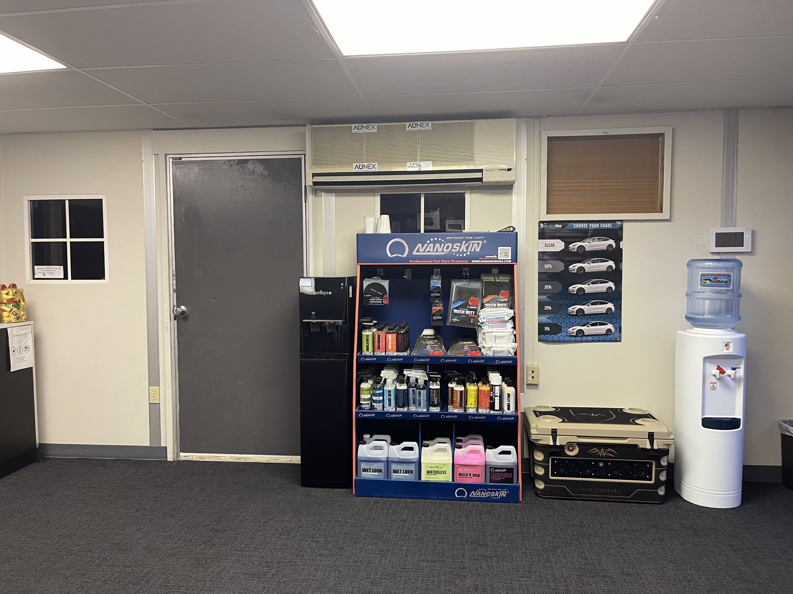 A room equipped with a refrigerator, water dispenser, and additional items, representing the diverse selection at the puresounds store.